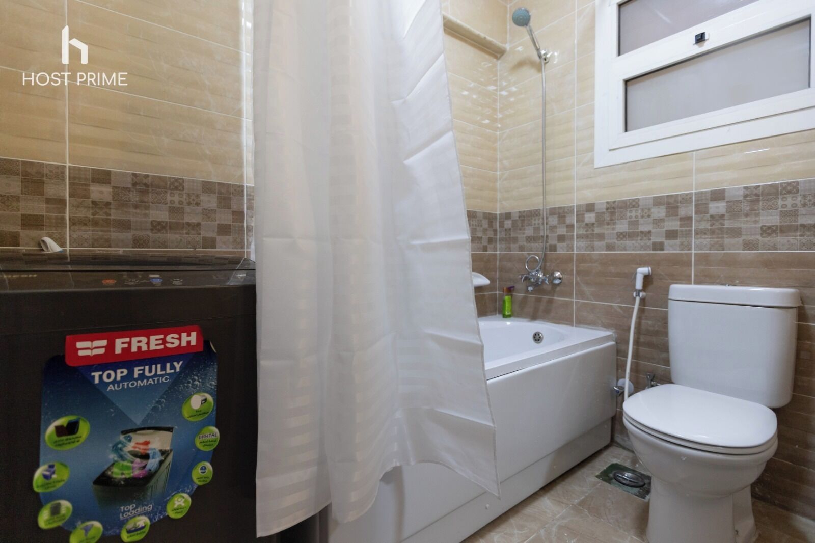 A bathroom with a shower, toilet, and bathtub. There is a sign for a fresh laundry service on the wall.