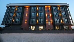 A modern hotel building with multiple floors, large windows, and a prominent sign indicating it is a hotel. - Edirne Gezgin Hotel (Edirne)