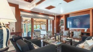 A spacious living area with a large flat-screen TV, comfortable seating, and a modern design. - Zenith Villa | Luxury - 6 Bedroom Villa in Surin with Sea View (Cheong Thale)