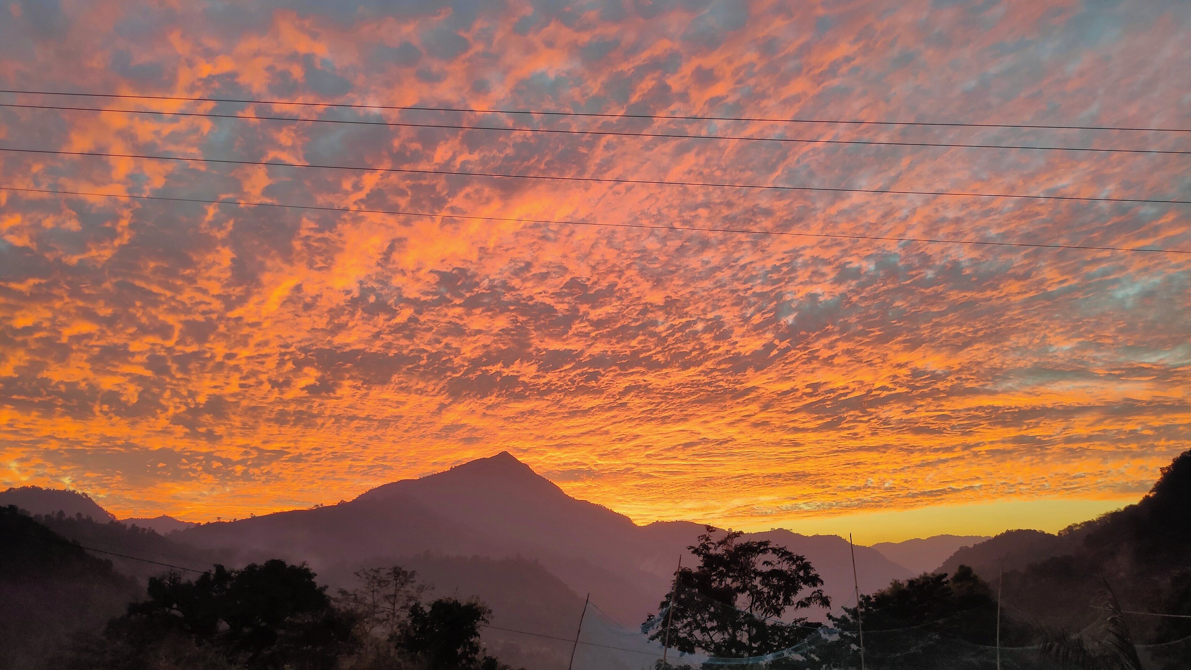 A mountain range at sunset with a clear sky.