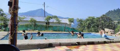 Outdoor pool, pool umbrellas, sun loungers