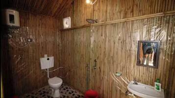 A bathroom with a toilet, sink, and mirror.
