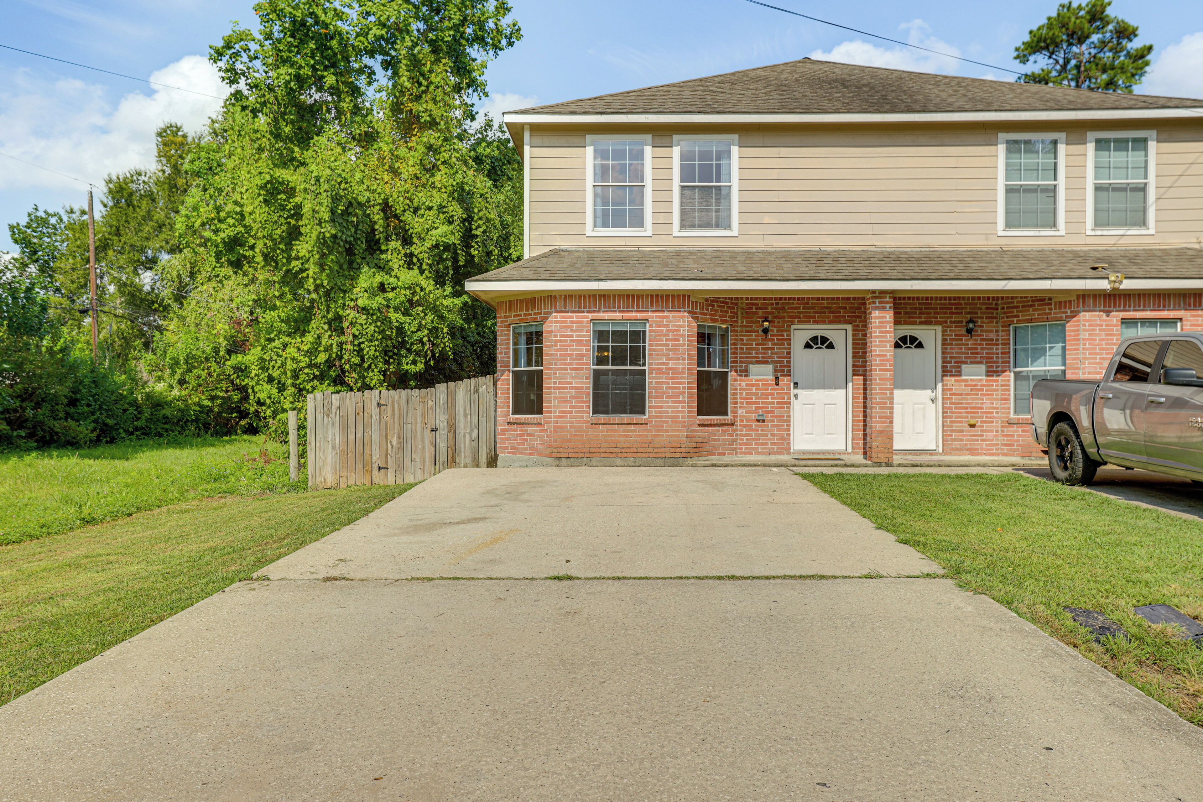 A two-story house with a front garage and a driveway.
