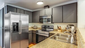 A modern kitchen with stainless steel appliances, granite countertops, and dark cabinetry. - Close to Everything! Quiet Retreat in Bend (Bend)