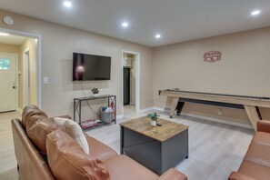 A living room with a brown leather sofa, a coffee table, a flat-screen TV, and a pool table. - OU Home Base! 1/2 Mi to Oklahoma Memorial Stadium (Norman)