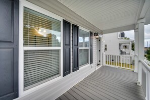 A covered porch with white railings and a wooden deck. - Walk to Beach: Group Getaway in Coastal Virginia (Norfolk)