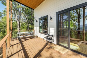 A wooden deck with a bench and chairs, large sliding glass doors, and a view of trees. - 12 Mi to Asheville: Mtn-view Gem in Weaverville (Weaverville)
