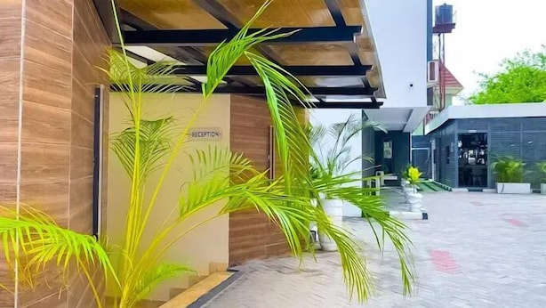 A reception area with a wooden facade and a sign labeled "RECEPTION." - Saint Tropez Hotel and Suites (Abuja)