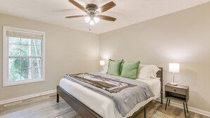 A bedroom with a bed, a nightstand, a ceiling fan, and a window. - 2 Mi to Tiger Territory! Condo w/ Community Pool (Auburn)