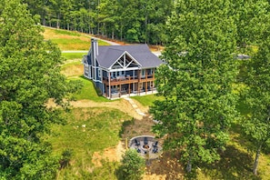 A large house with a wrap-around porch and a fire pit in the yard. - Cozy Blue Ridge Cabin: Game Room & Mountain Views (Blairsville)