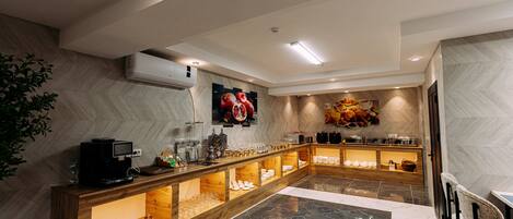 A modern kitchen with a marble floor, wooden counter, and various kitchen appliances.
