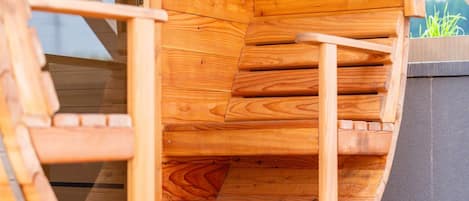 A wooden staircase leading to an upper level, with a door and a small window.