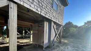 A wooden structure with a sign reading "Kite Tales." - Chasing Sunsets 4 Bedroom Cottage (Hatteras)