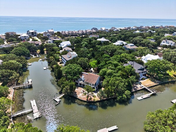 An aerial view of a residential area with houses, a river, and a dock. - Sunny Pointe 4 Bedroom Home (Georgetown)