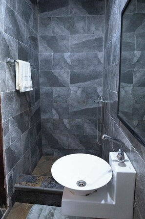 Een douche, handdoeken, zeep, shampoo