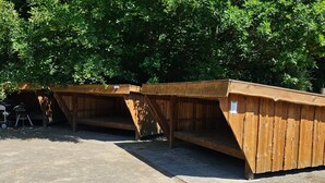 A row of wooden structures with benches, likely for outdoor seating or rest areas.