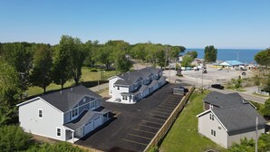 A coastal hotel with a parking lot, a small beach area, and a view of the sea. - Lakeside Bliss- Close to Highmark Stadium, home of the Bills! (Angola)