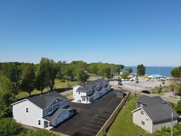 A coastal hotel with a parking lot, a small beach area, and a view of the sea. - Lakeside Bliss- Close to Highmark Stadium, home of the Bills! (Angola)