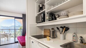 A modern kitchen with a dishwasher, a coffee maker, and a sink. - Charming Flat With sea View - 1BR - 2P - Bocca (Cannes)
