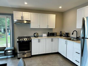 Fridge, microwave, stovetop, cookware/dishes/utensils