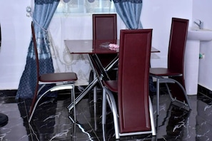 Deluxe Apartment, Balcony, City View | Dining room