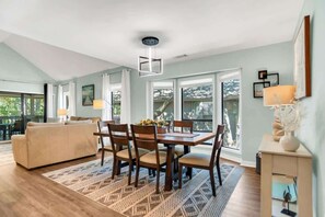 Un espace repas comprenant une table et des chaises, un canapé et un tapis.