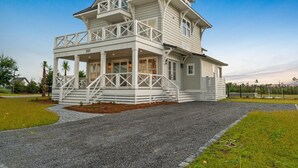A two-story house with a balcony, a covered porch, and a number '201' on the front. - Sail Away: Private Pool, Hot Tub, Pet Friendly (Mexico Beach)