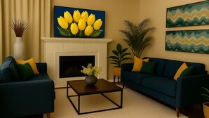 A living room with a fireplace, two sofas, a coffee table, and decorative plants. - Spacious Home Quiet Neighborhood nr Downtown (Carrollton)