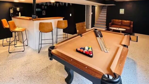 A pool table with a bar area and seating in the background. - No cleanup chores-Fenced yard, fire pit. Close to I81, downtown. Walk to casino. (Bristol)