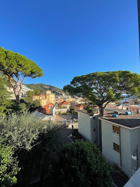 A residential area with a view of a town, including buildings and trees.