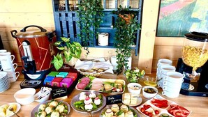 A breakfast buffet with various food items, coffee machines, and a coffee pot. - Cottage in Duszniki Zdroj With Panoramic View (Szczytna)