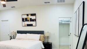 A bedroom with a bed, bedside tables, a ceiling fan, a painting, and a closet. - Meet. Play. Stay. • Relax & Play in Orlando (Orlando)