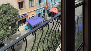 A view of colorful buildings with balconies, a spa, and outdoor seating. - BLESSED Hotel Phu Quoc (Phu Quoc)