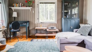 A cozy room with a desk, chair, bed, and a cabinet.