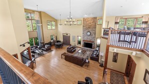 A spacious living area with a fireplace, multiple seating options, and a view of the outdoors.