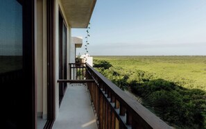 A balcony with a view of a green landscape. - Oceanfront Escape – Two-Level Penthouse with Private Rooftop & Pool (Tulum)