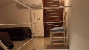 A multi-level interior with a staircase connecting floors.