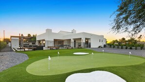 A modern building with a well-maintained lawn and a putting green. - The Showstopper Scottsdale (Scottsdale)
