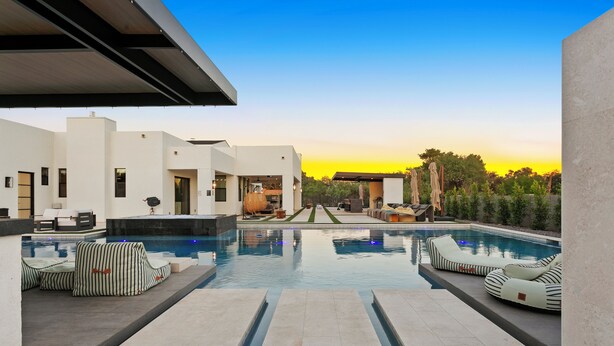 A modern outdoor pool area with lounge chairs and a clear view of the sky. - The Showstopper Scottsdale (Scottsdale)