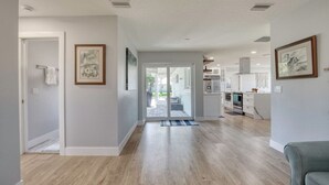 A modern kitchen with white cabinets and stainless steel appliances. - Drift and Dune Beach, Pet Friendly, Steps to Beach (Ponce Inlet)