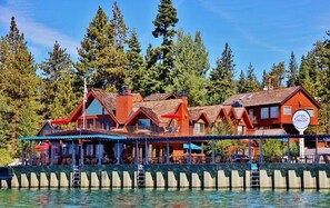 A waterfront property with multiple wooden buildings, a dock, and a pier. - Tahoe Vista Inn Suite 6 (Tahoe Vista)