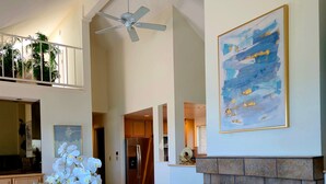 A spacious living room with a fireplace, a ceiling fan, and a dining area. - Tahoe Vista Inn Suite 7 (Tahoe Vista)
