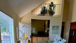 A living room with a sofa, a coffee table, and a potted orchid. - Tahoe Vista Inn Suite 7 (Tahoe Vista)