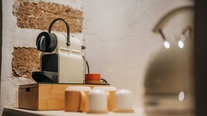 A kitchen counter with a coffee machine, a kettle, and various containers. - Suite with private spa in the heart of Palermo✨️ (Palermo)