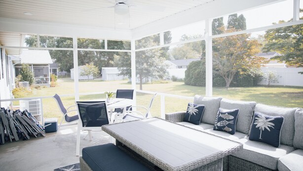 A covered outdoor seating area with a sofa, chairs, and a table. - 4BR Beach House Sleeps 12/Screened Porch/Parking for 6 cars /Rehoboth (Rehoboth Beach)