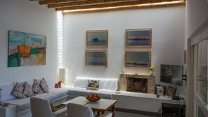 A modern living room with a sofa, chairs, a coffee table, and a fireplace. - Casa Paracas by Wynwood House (Paracas)