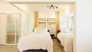 A bedroom with two beds, a wardrobe, and a bedside table. - Baggage OK！Clean, Comfy bed Stay- Dotombori Haven (大阪市中央区島之内2丁目)