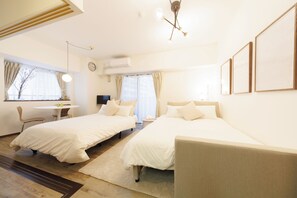 A hotel room with two beds, a desk, and a chair. - Baggage OK！Clean, Comfy bed Stay- Dotombori Haven (大阪市中央区島之内2丁目)