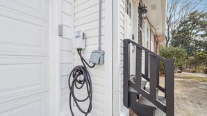 A garage door with a power outlet and a cable connected to it.