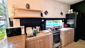 A modern kitchen with a built-in stove, microwave, and refrigerator.